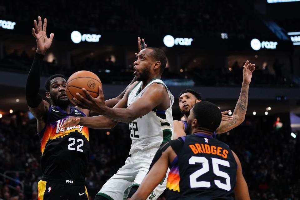 Milwaukee Bucks' Khris Middleton drives if traffic during the first half of an NBA basketball game Sunday, March 6, 2022, in Milwaukee . (AP Photo/Morry Gash)