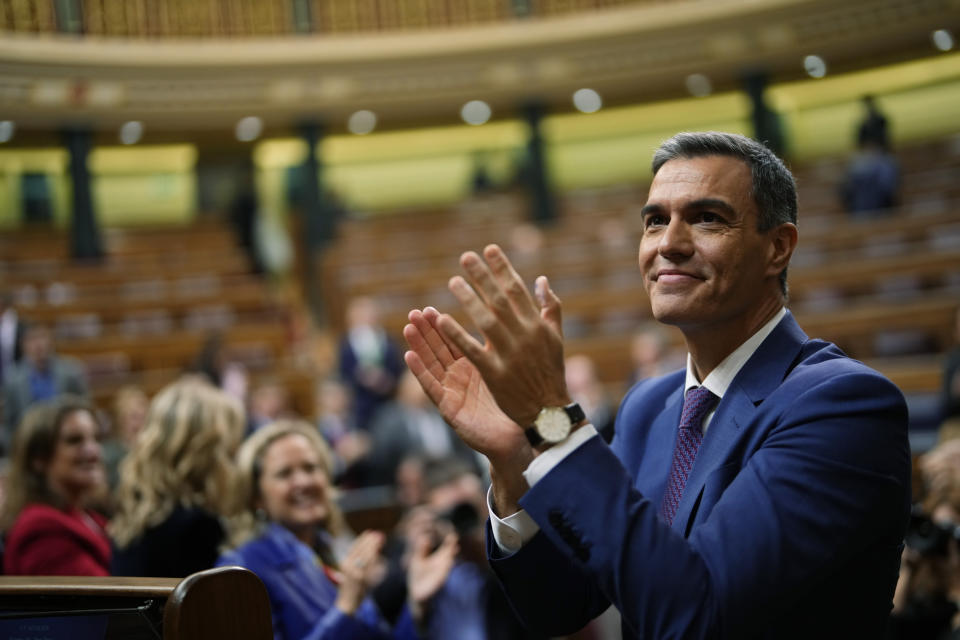 FILE, Spain's acting Prime Minister Pedro Sanchez applauds he was chosen by a majority of legislators to form a new government after a parliamentary vote at the Spanish Parliament in Madrid, Spain, Thursday, Nov. 16, 2023. Sánchez says he will continue in office "even with more strength" after days of reflection. Sánchez shocked the country last week when he said he was taking five days off to think about his future after a court opened preliminary proceedings against his wife on corruption allegations. (AP Photo/Manu Fernandez, File)