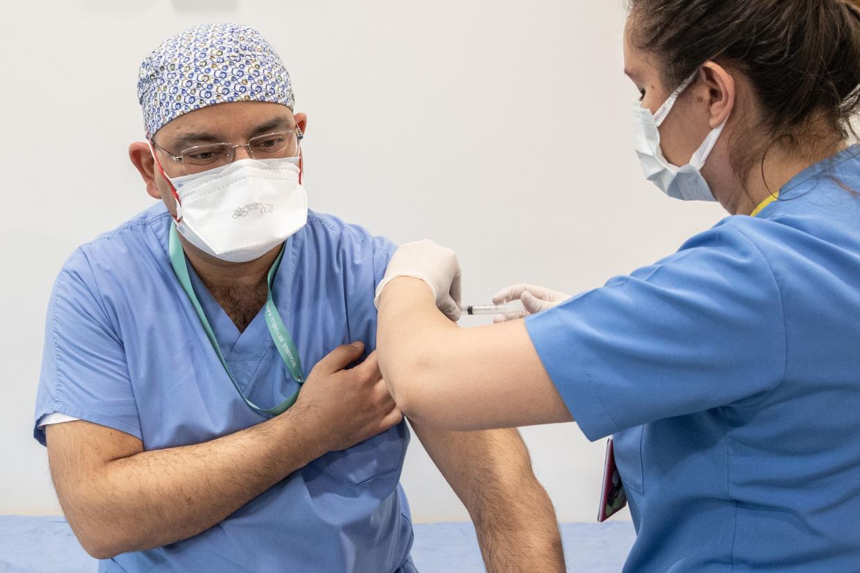 A healthcare worker vaccinates a colleague against COVID-19 with Sinovac's Coronavac vaccine at Prof. Dr. Cemil Tascioglu City Hospital on Jan. 14, 2021, in Istanbul, Turkey. Turkey received three million doses of China's Sinovac Coronavac vaccine on December 30 and has begun the first phase of vaccinations starting with the country's more than 1.1 million medical workers.