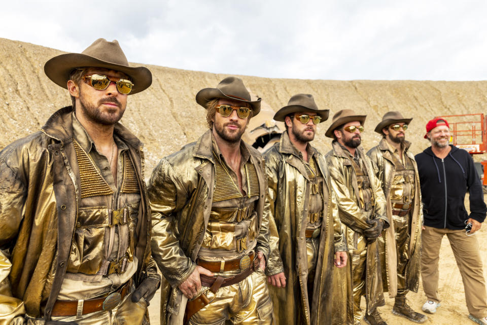 This image released by Universal Pictures shows actors, from left, Ryan Gosling and Aaron Taylor-Johnson, with stunt actors Ben Jenkin, Logan Holladay, and Justin Eaton, posing with director David Leitch on the set of "The Fall Guy." (Eric Laciste/Universal Pictures via AP)