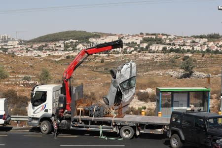 Car is removed from the scene of what Israeli military said is a car-ramming attack near the settlement of Elazar in the Israeli-occupied West Bank