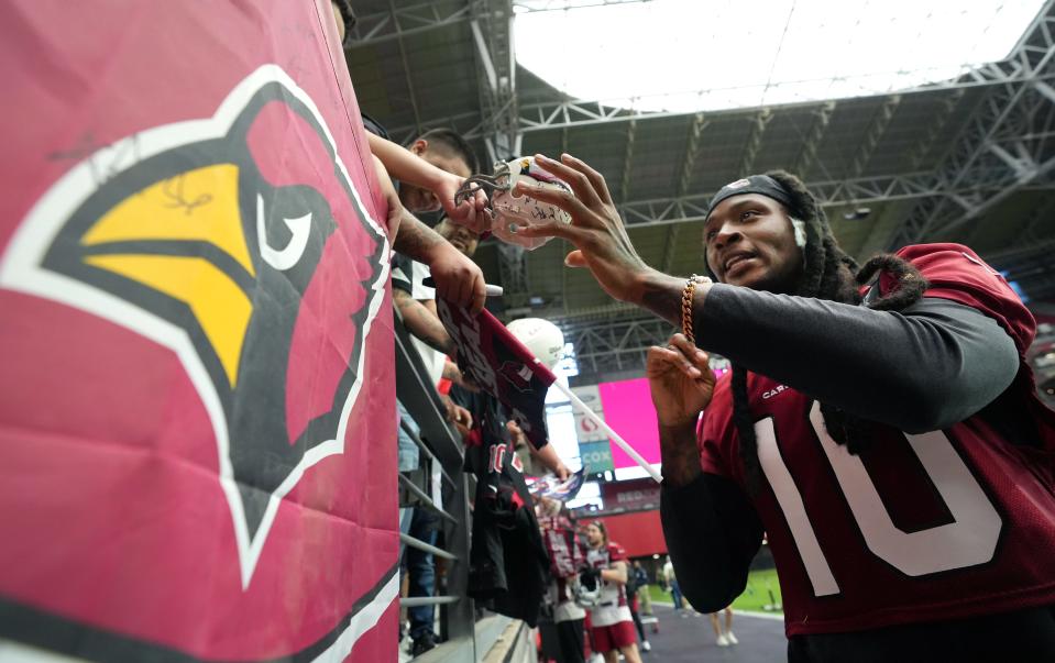 Wide receiver DeAndre Hopkins signs autographs for fans during the Arizona Cardinals Back Together Saturday Practice at State Farm Stadium in Glendale, Ariz. on Saturday, July 30, 2022. 
