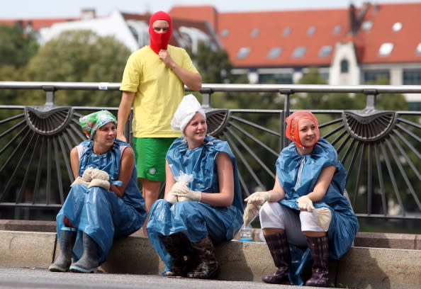 Participants in the annual Vegetable Battle (Gemueseschlacht) wait for the beginning of the fight on the Oberbaumbruecke on September 2, 2012 in Berlin, Germany. The event pits Kreuzberg district residents againts those of Friedrichshain for control of the Oberbaumbruecke (Oberbaum Bridge), and the two sides pelt each other with rotten vegetables, pet food, ketchup, chicken drumsticks, flour, water guns and styrofoam bats until one side has pushed the other from the bridge. Friedrichshain won the war, in revenge for Kreuzberg's victory the previous year. (Photo by Adam Berry/Getty Images)