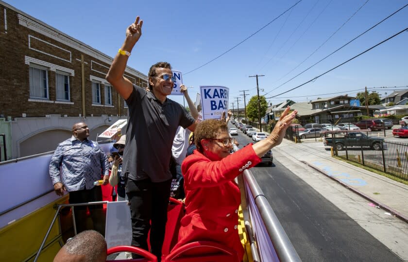 LOS ANGELES, CA - JUNE 5, 2022: Mayoral candidate Rep. Karen Bass and former Mayor Antonio Villaraigosa waves to onlookers from a double-decker bus as her campaign canvasses the city on "Get Out the Vote" tour on June 5, 2022 in Los Angeles, California.(Gina Ferazzi / Los Angeles Times)