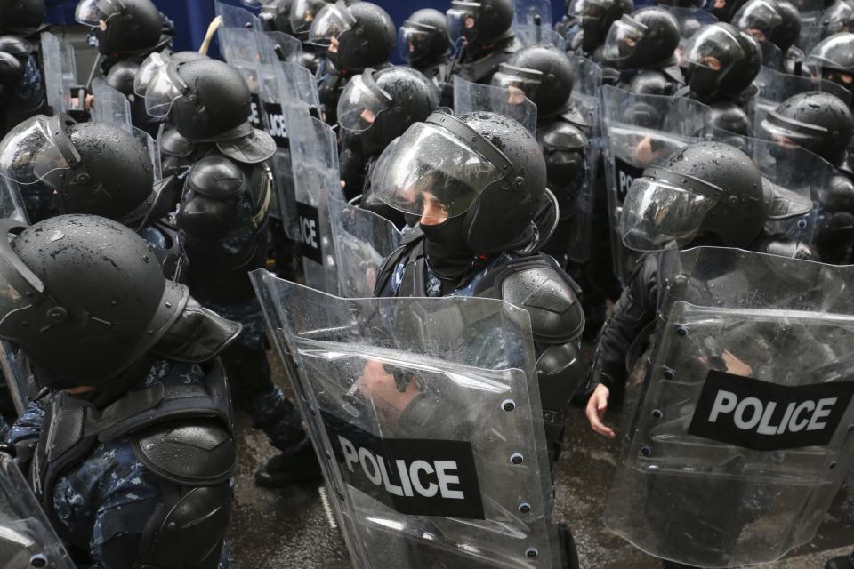 Riot police block a street to prevent demonstrators during an opposition protest against "the Russian law" near the Parliament building in the center of Tbilisi, Georgia, Tuesday, May 14, 2024. The Georgian parliament on Tuesday approved in the third and final reading a divisive bill that sparked weeks of mass protests, with critics seeing it as a threat to democratic freedoms and the country's aspirations to join the European Union. (AP Photo/Zurab Tsertsvadze)