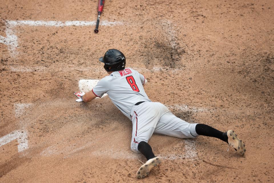 Texas Tech shortstop Kurt Wilson slides into home during the Red Raiders' 6-4 victory Sunday at Oklahoma State. The eighth-ranked Red Raiders swept the three-game series from the third-ranked Cowboys.