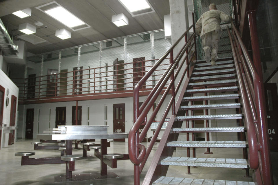 GUANTANAMO BAY NAVAL BASE, CUBA - JULY 23: In this image reviewed by the U.S. Military, a guard walks up a stairway inside a high-security portion of the detention center July 23, 2008 at Guantanamo Bay U.S. Naval Base, in Cuba. The military base is providing the location for the trial of Salim Hamdan, the former driver for Osama bin Laden, who is charged with conspiracy and aiding terrorism and is the first prisoner to face a U.S. war-crimes trial since World War II. (Randall Mikkelsen-Pool/Getty Images)