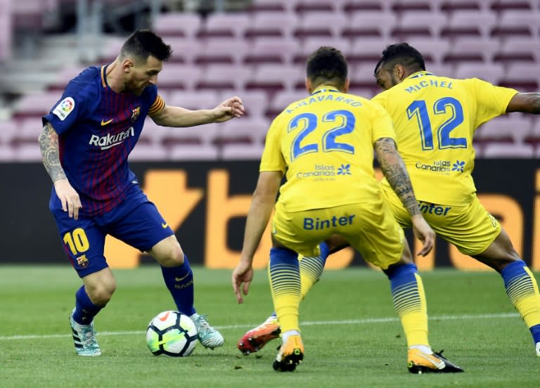 Barcelona's forward Lionel Messi (L) challenges Las Palmas' midfielder Ximo Navarro and defender Michel at the Camp Nou stadium in Barcelona on October 1, 2017