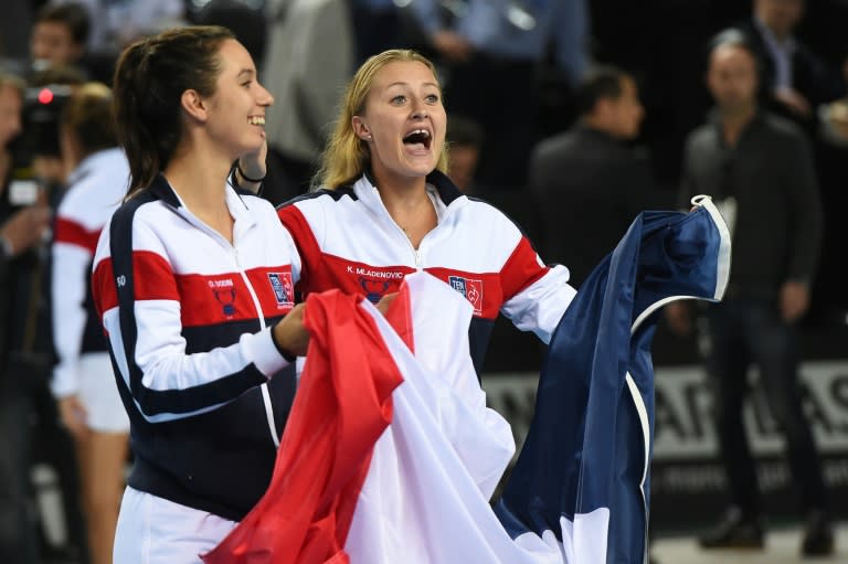 France's Fed Cup players Oceane Dodin (L) and Kristina Mladenovic celebrate after winning against Italy in Marseille, southern France, on February 7, 2016