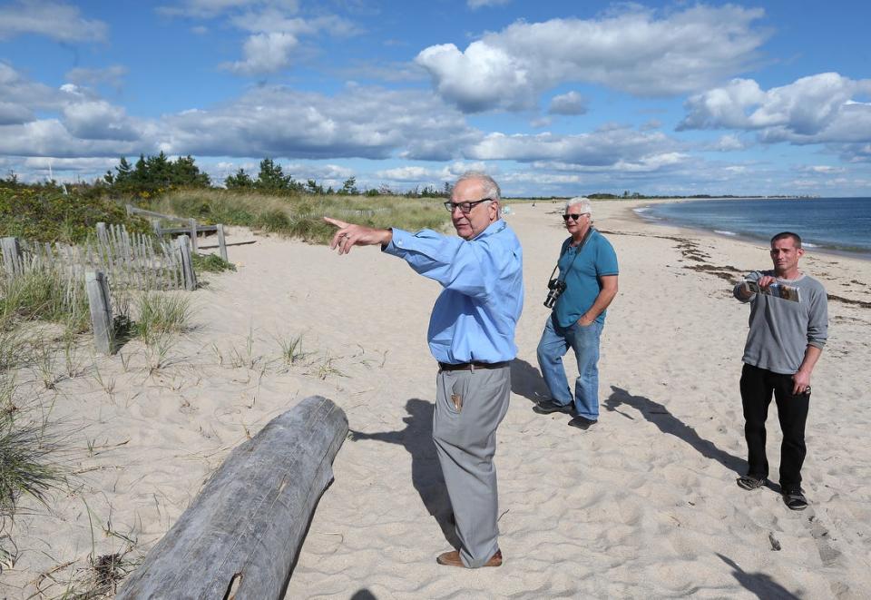 Attorney Michael Rubin, left, with fellow shoreline activists Stephen Cersosimo, center, and Ben Weber, points out Spring Avenue Extension, which they assert should be a public right of way to Quonochontaug Barrier Beach.