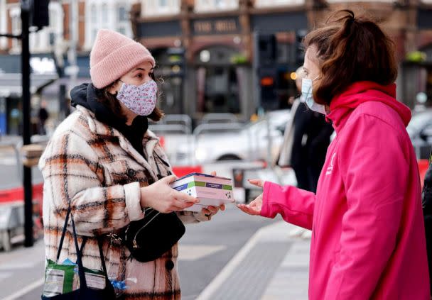 PHOTO: Volunteers hand out boxes of Covid-19 rapid antigen Lateral Flow Tests in London, Jan. 3, 2022. (Tolga Akmen/AFP via Getty Images, FILE)