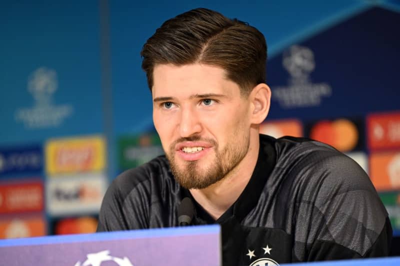 Borussia Dortmund's goalkeeper Gregor Kobel answers questions from journalists during a press conference ahead of Tuesday's UEFA Champions League Round of 16 First Leg soccer match against PSV Eindhoven. Federico Gambarini/dpa