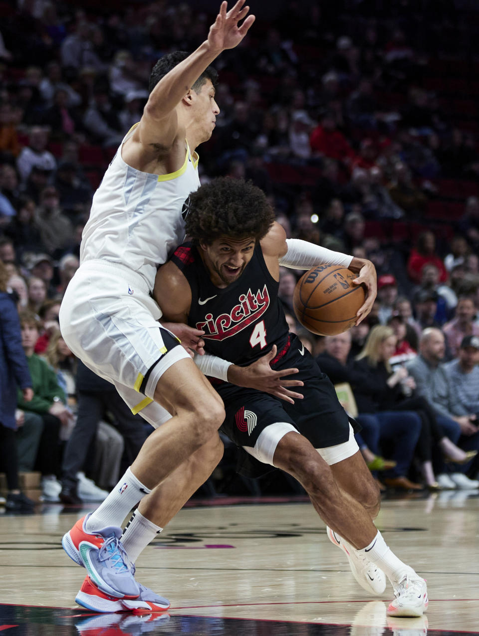 Portland Trail Blazers guard Matisse Thybulle, right, collides with Utah Jazz forward Simone Fontecchio during the first half of an NBA basketball game in Portland, Ore., Thursday, Dec. 14, 2023. (AP Photo/Craig Mitchelldyer)