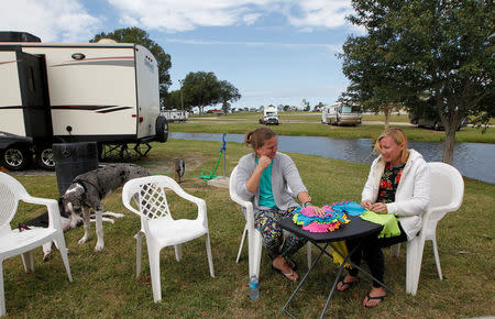 Danielle Taylor and Brittany Gooding (R) of Hollywood, Florida sit outside their trailer while riding out Hurricane Irma at Atlanta Motor Speedway in Hampton, Georgia, U.S., September 10, 2017. REUTERS/Tami Chappell