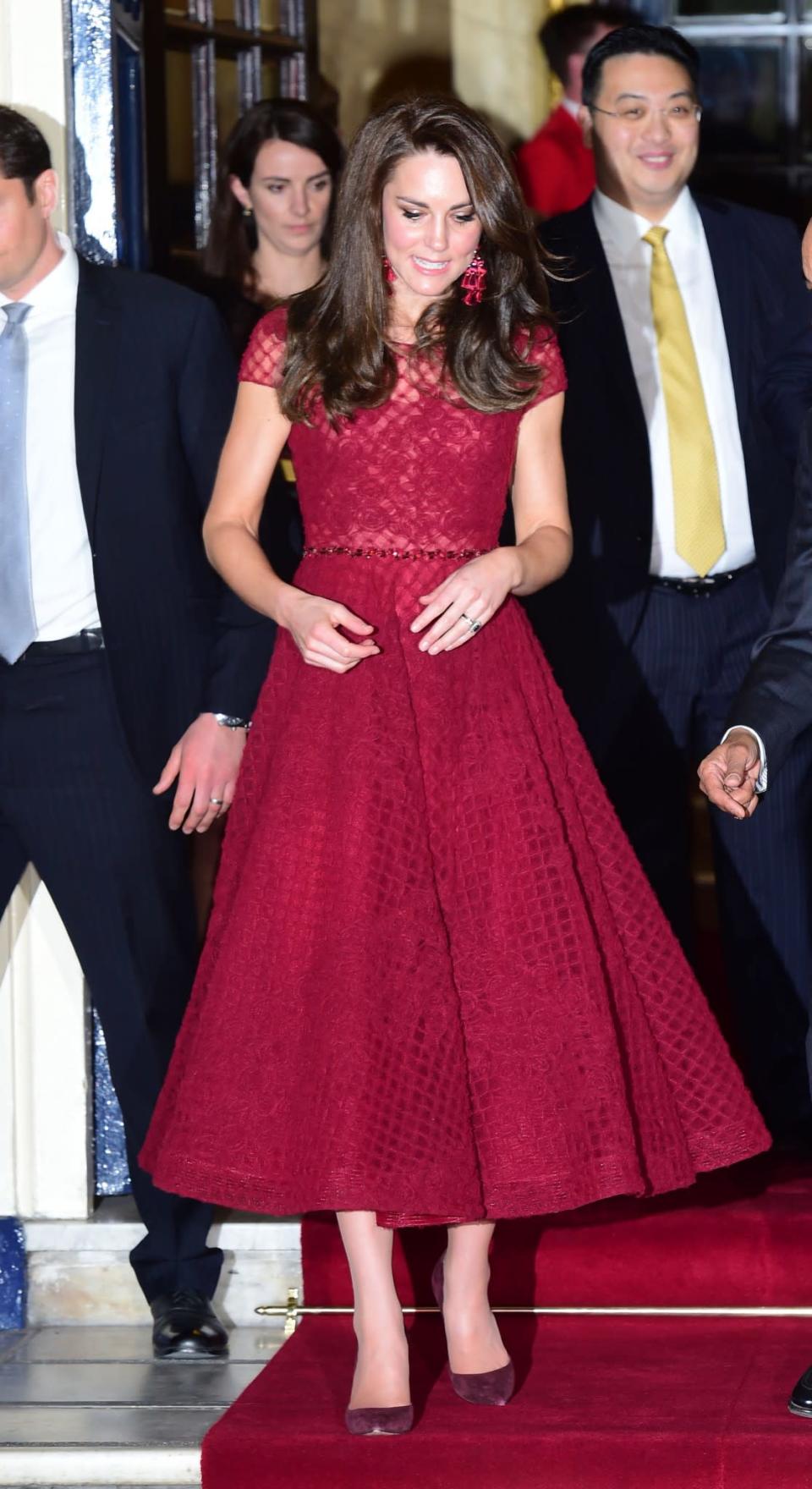 <p>Kate donned the colour of the season for the opening night of West End musical, <i>42nd Street</i>. Wearing a claret midi-length dress by Marchesa Notte (that cost £1,105), the Duchess opted for some seriously fashion-forward accessories including a pair of pom pom statement earrings from Kate Spade. Gianvito Rossi pumps and a matching Mulberry clutch topped off the look.<br><i>[Photo: PA]</i> </p>