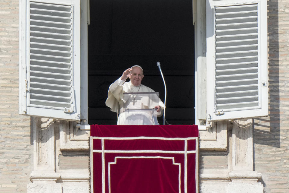 Pope Francis greets the crowd as he recites the Angelus noon prayer from the window of his studio overlooking St.Peter's Square, at the Vatican, Sunday, Jan. 23, 2022. (AP Photo/Andrew Medichini)