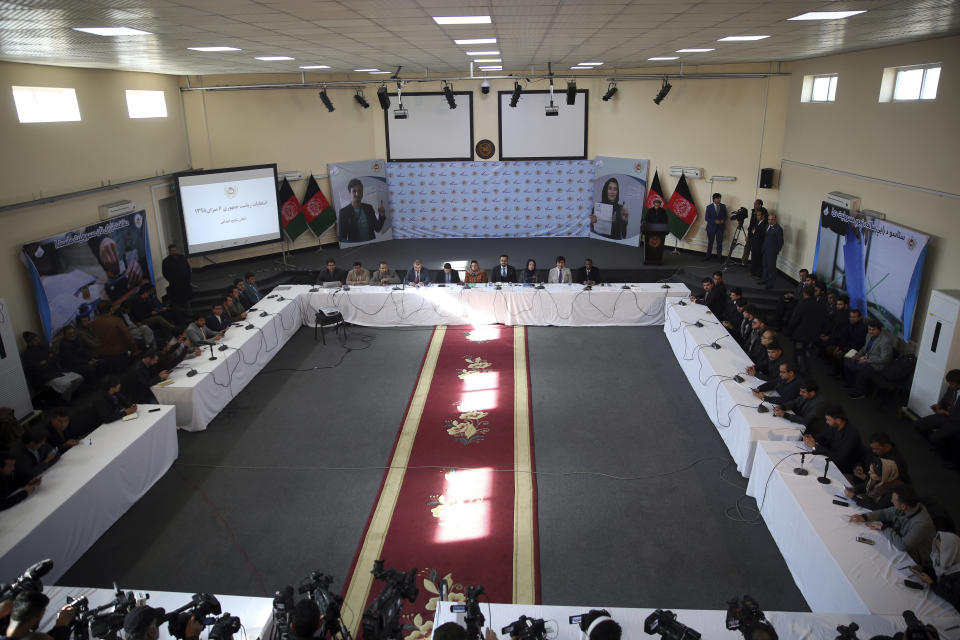 Hawa Alam Nuristani, chief of Election Commission of Afghanistan, center, speaks during a press conference at the Independent Election Commission office in Kabul, Afghanistan, Sunday, Dec. 22, 2019. Afghanistan's election commission said President Ashraf Ghani has won a second term, earning 50.64% of a preliminary vote count announced Sunday, but his opponents can still challenge the result. (AP Photo/Rahmat Gul)