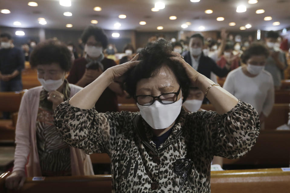 A Christian wearing a face mask to help protect against the spread of the new coronavirus prays during a service at the Yoido Full Gospel Church in Seoul, South Korea, Sunday, May 31, 2020. (AP Photo/Ahn Young-joon)