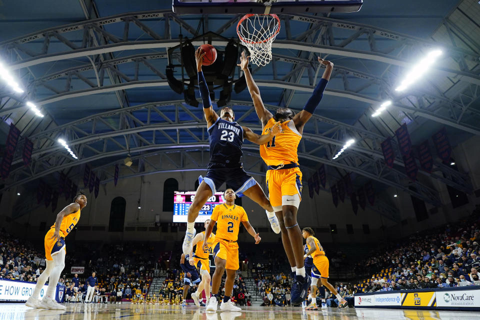 Villanova's Jermaine Samuels (23) goes up for a shot against La Salle's Tegra Izay (11) during the first half of an NCAA college basketball game, Sunday, Nov. 28, 2021, in Philadelphia. (AP Photo/Matt Slocum)