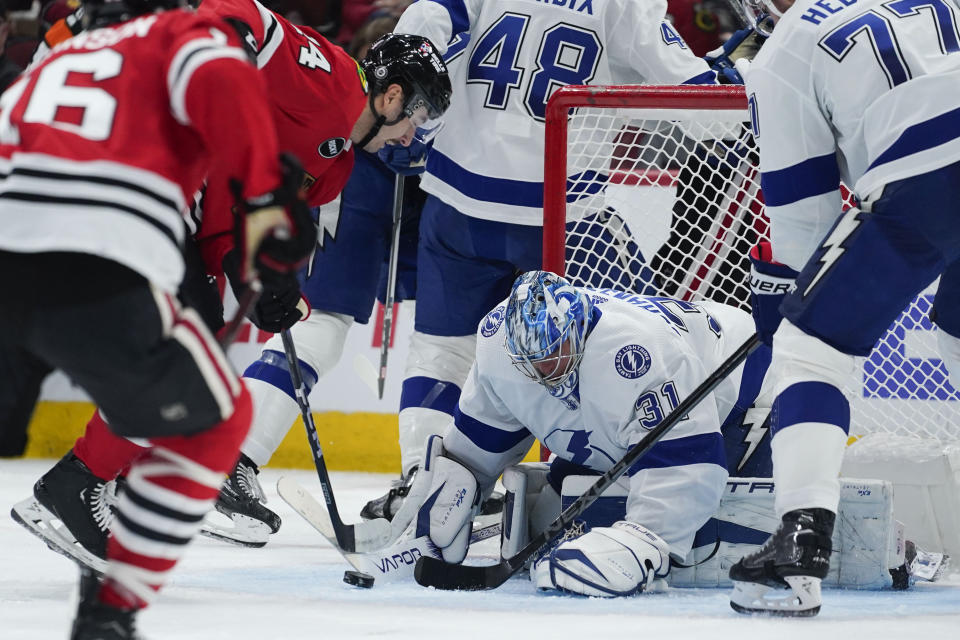 Tampa Bay Lightning goaltender Jonas Johansson (31) makes a save against Chicago Blackhawks left wing Boris Katchouk (14) during the second period of an NHL hockey game Thursday, Nov. 16, 2023, in Chicago. (AP Photo/Erin Hooley)