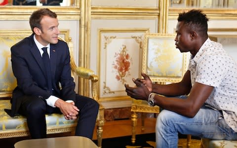 French President Emmanuel Macron, left, meets with Mamoudou Gassama, 22, from Mali, at the presidential Elysee Palace in Paris, - Credit: AP POOL