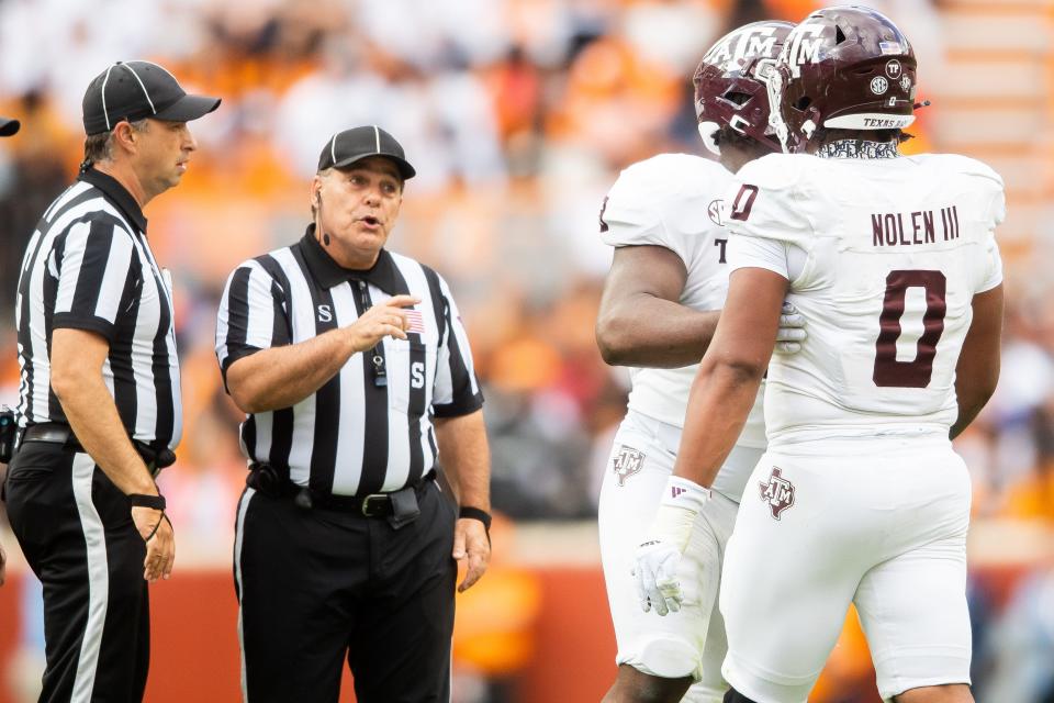 A referee warns Texas A&M defensive lineman Walter Nolen (0) during a football game between Tennessee and Texas A&M at Neyland Stadium in Knoxville, Tenn., on Saturday, Oct. 14, 2023.