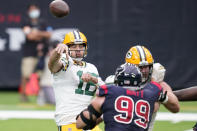 Green Bay Packers quarterback Aaron Rodgers, left, throws over Houston Texans defensive end J.J. Watt (99) during the first half of an NFL football game Sunday, Oct. 25, 2020, in Houston. (AP Photo/Sam Craft)
