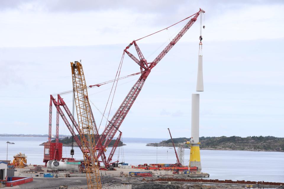 A wind turbine tower being assembled at Gulen, Norway, for the Hywind Tampen floating wind farm. When completed, the tower will be just over 325 feet high, and extend a full 300 feet underwater.