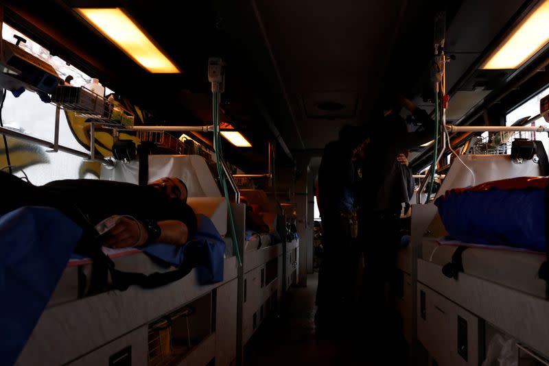 Ukrainian volunteer medics use a converted bus to transport wounded Ukrainian soldiers from the eastern frontline near Bakhmut to a hospital in Dnipro