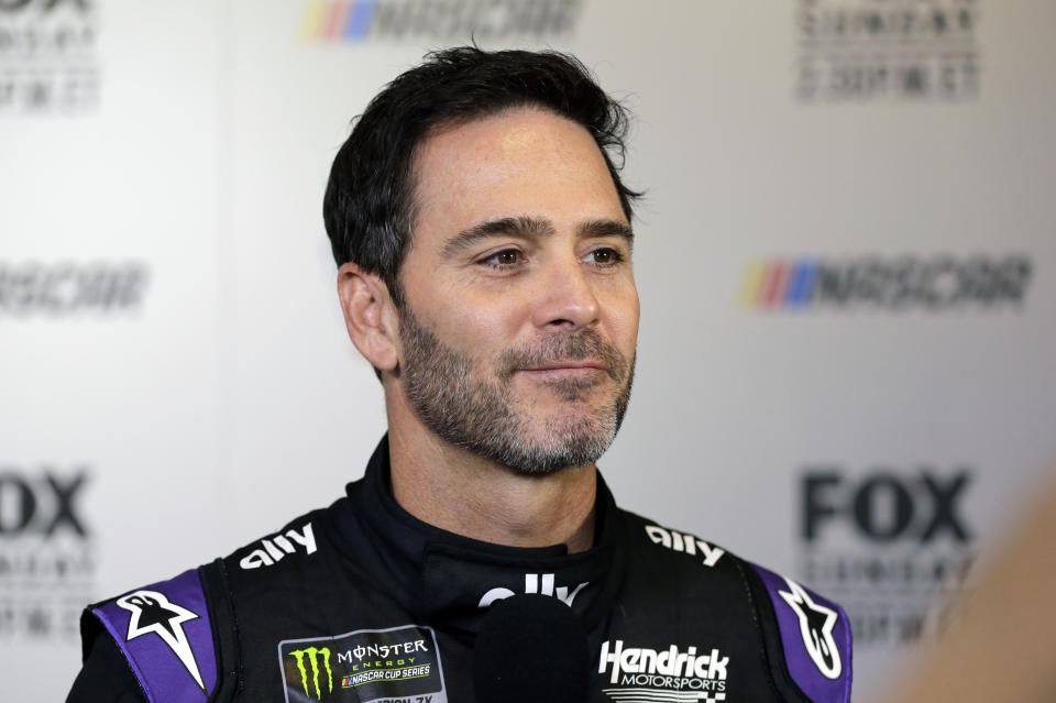 FILE - In this Feb. 13, 2019, file photo, driver Jimmie Johnson smiles during media day for the NASCAR Daytona 500 auto race at Daytona International Speedway in Daytona Beach, Fla. Seven-time NASCAR champion Jimmie Johnson has twice tested negative for the coronavirus and has been cleared to race Sunday, July 12, 2020 at Kentucky Speedway. Johnson missed the first race of his Cup career when he tested positive last Friday. (AP Photo/Terry Renna, File)