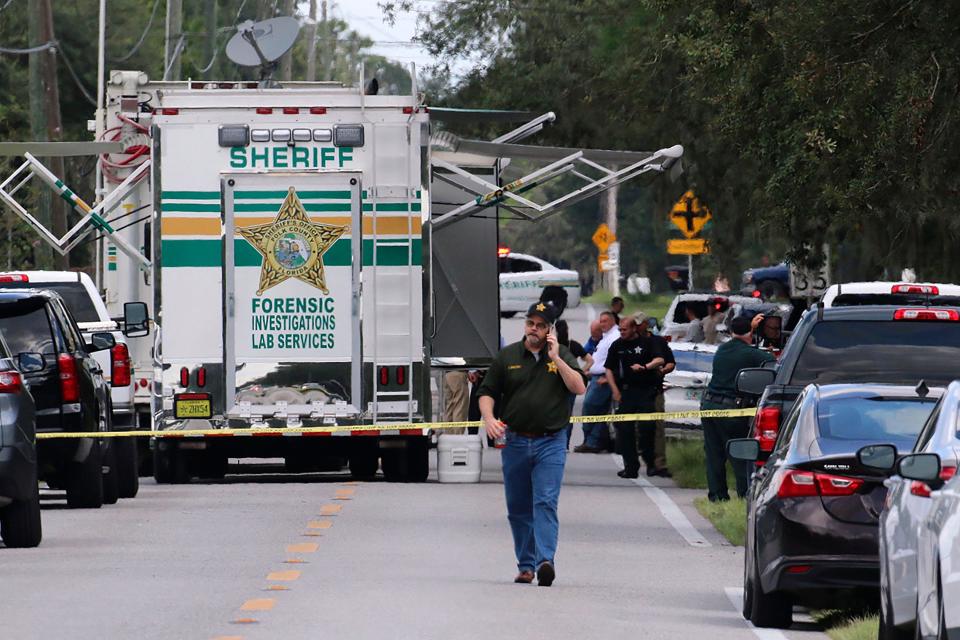 Polk County, Fla., sheriff's officials work the scene of a multiple-fatality shooting Sept. 5 in Lakeland, Fla. Four people are dead, including a mother who was still cradling her deceased baby, after a shootout between deputies and a suspect.