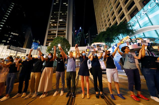 Protesters hold hands to form a human chain during a rally to call for political reforms in Hong Kong's Central district, China, August 23, 2019. 