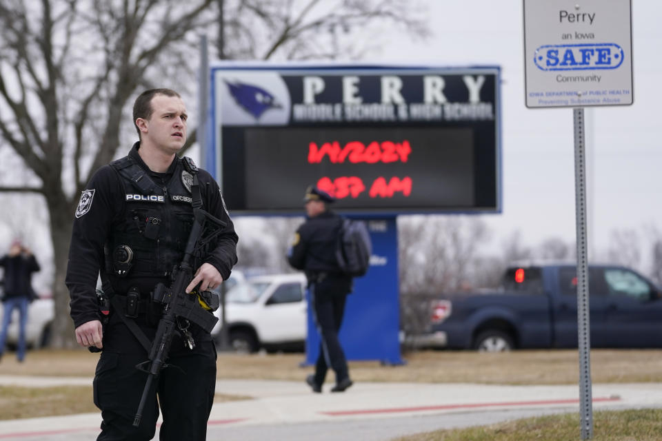 FILE - Police respond to Perry High School in Perry, Iowa., Jan. 4, 2024. Police say there has been a shooting at the city's high school. An Iowa principal who put himself in harm's way to protect students during a school shooting earlier this month has died. Caldwell Parrish Funeral Home & Crematory confirmed the death of Perry High School Principal Dan Marburger after the family announced it on a GoFundMe page. Marburger died Sunday morning, Jan. 14 after he was critically injured during the Jan. 4 attack. (AP Photo/Andrew Harnik, file)