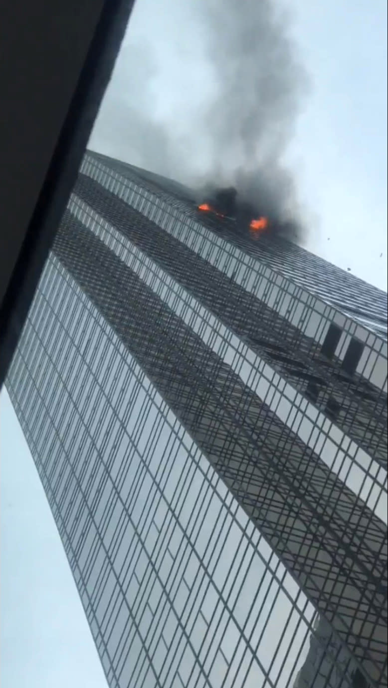 <p>Debris falls during a fire at Trump Tower in New York, April 7, 2018 in this still image from video obtained from social media. (Photo: Twitter@ZionLee_ /via Reuters) </p>