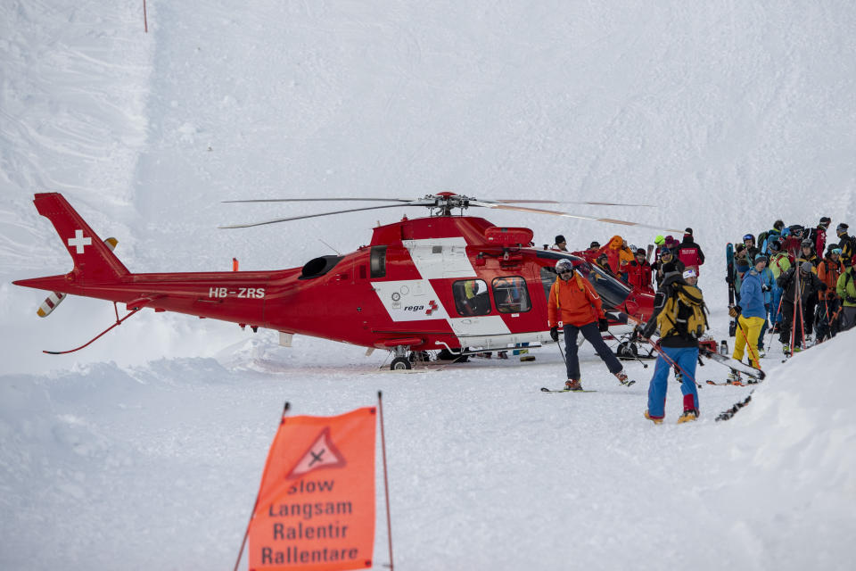 Rescue forces and helicopters still search for missed persons after an avalanche swept down a ski piste in the central town of Andermatt, canton Uri, Switzerland, Thursday, Dec. 26, 2019. Six people have been rescued, two of them with minor injuries but cantonal authorities fear that several other people may be buried. An extensive rescue operation is underway. (Urs Flueeler/Keystone via AP)