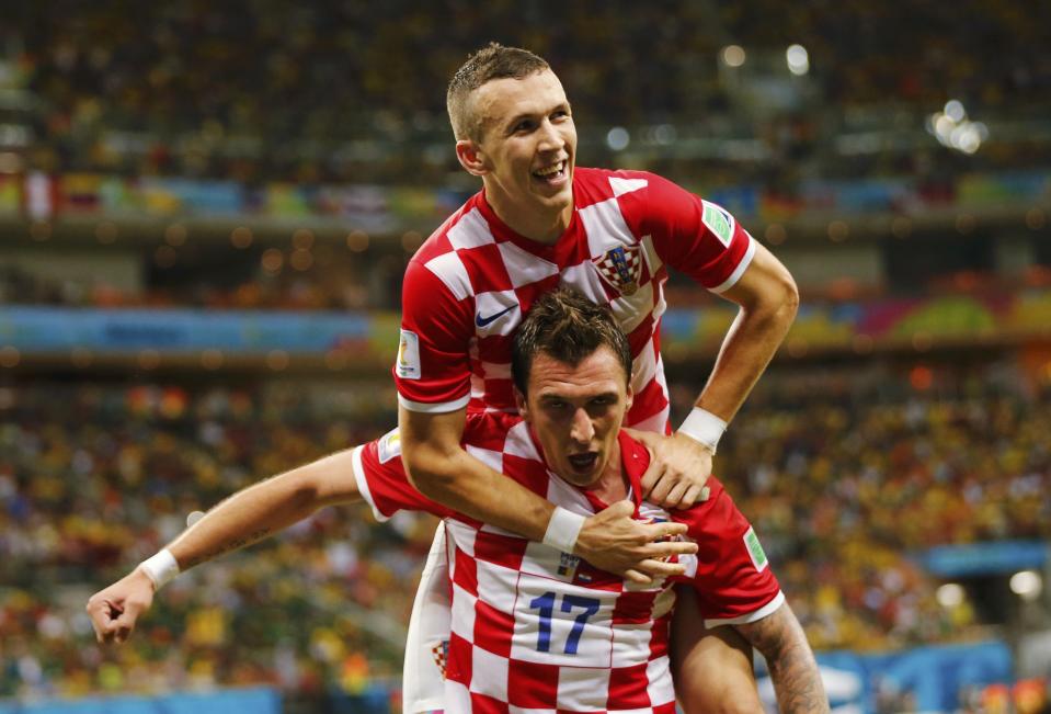 Croatia's Mandzukic celebrates after scoring a goal with teammate Perisic during their 2014 World Cup Group A soccer match against Cameroon at the Amazonia arena in Manaus