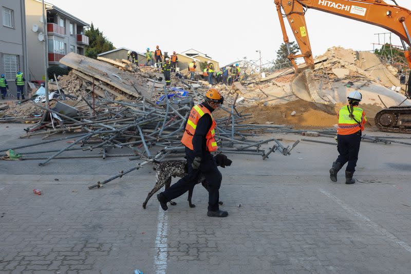 Rescuers work to rescue construction workers trapped under a building that collapsed in George