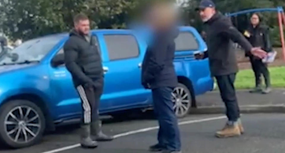 People arguing in a parking spot.