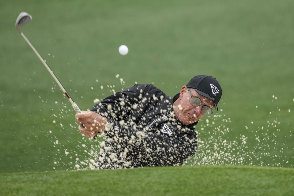 Phil Mickelson hits from the bunker on the second hole during the weather delayed third round of the Masters golf tournament at Augusta National Golf Club on Saturday, April 8, 2023, in Augusta, Ga. (AP Photo/David J. Phillip)