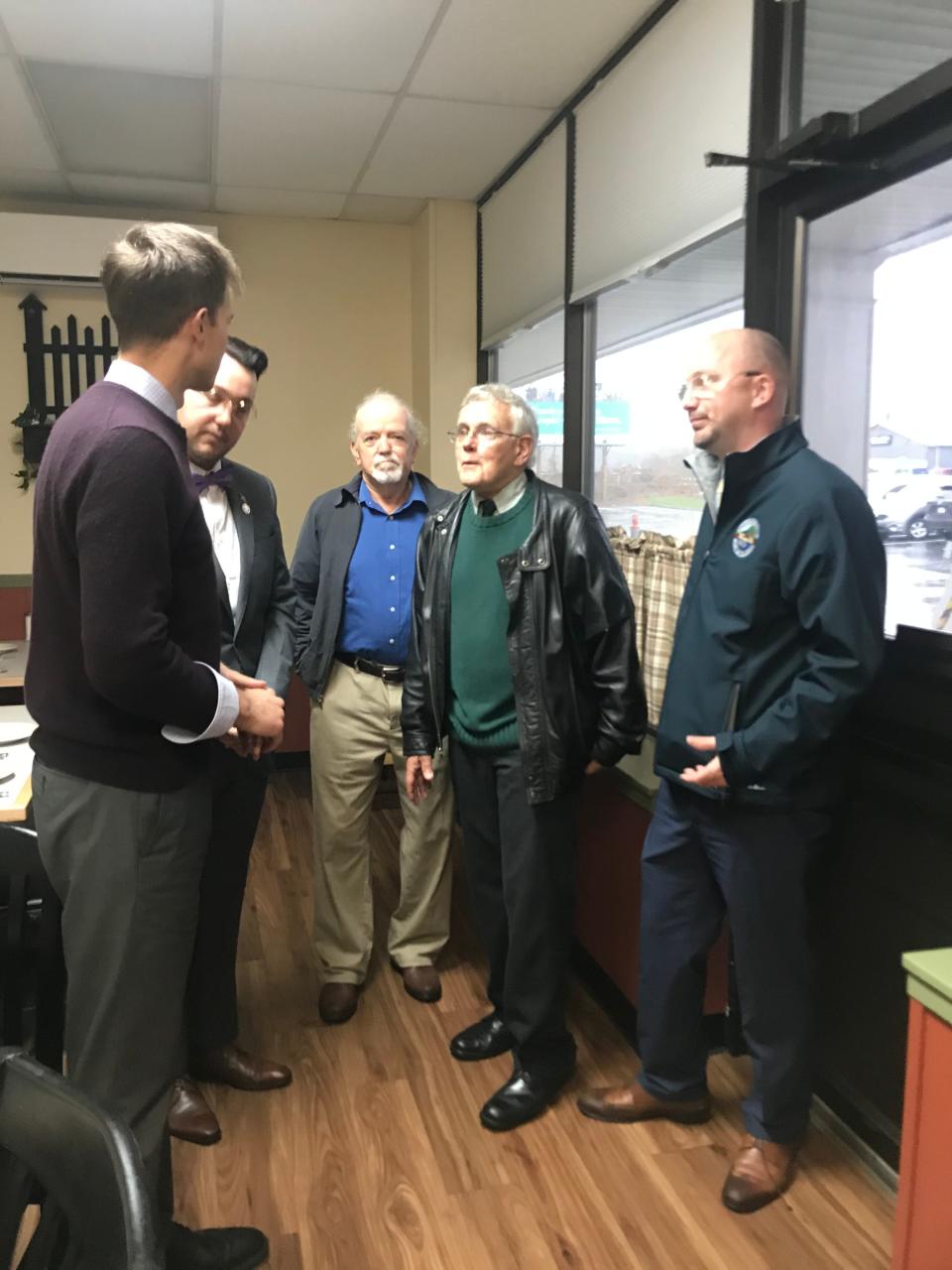 Dighton Selectman Leonard Hull, second from right, and Town Administrator Michael Mullen, right, speak with U.S. Rep. Jake Auchincloss, left, on a tour of the town on Friday, Nov. 12, 2021. Also pictured are former Dighton selectmen Brett Zografos, second from left, and Ken Pacheco.