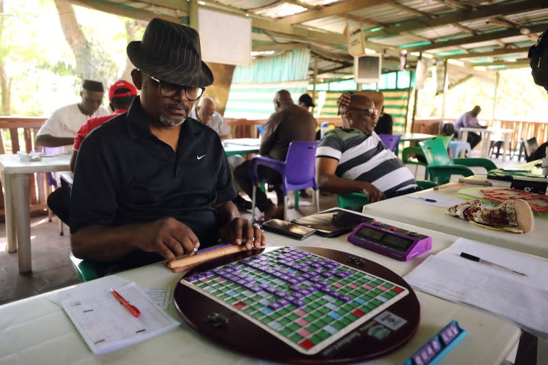 Anthony Ikolo, former President of the Nigeria scrabble federation arranges his tiles during a scrabble competition in Abuja.