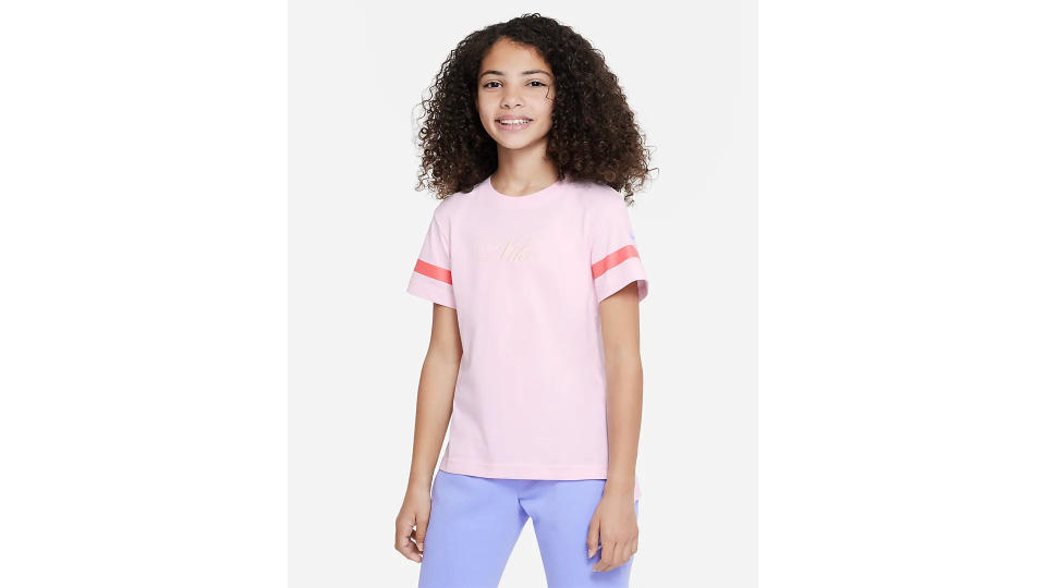 A photo of a girl wearing Nike Sportswear Older Kids' (Girls') T-Shirt. 