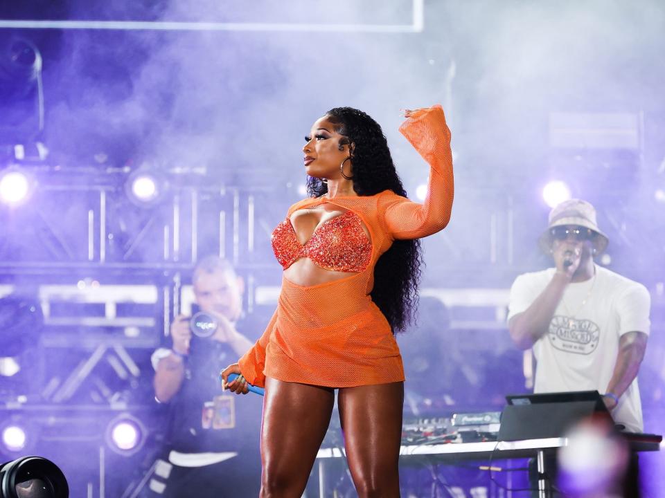 Megan Thee Stallion performs in a see-through orange outfit at 2021 Rolling Loud.