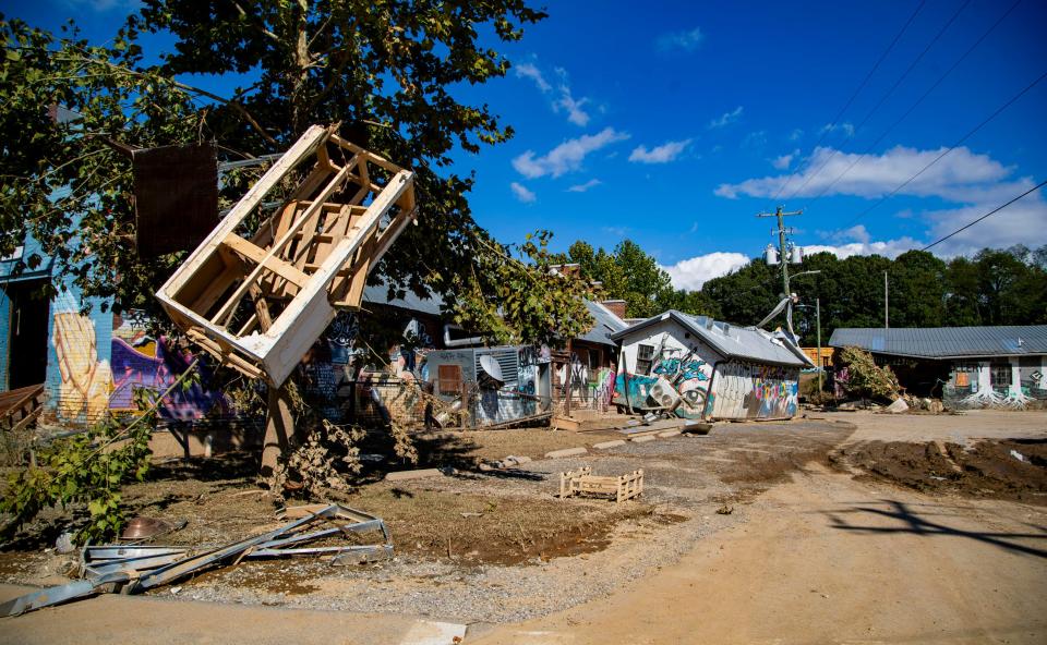 Debris surrounds The Wedge in the River Arts District in Asheville Wednesday afternoon after being washed away by the floodwaters of Helene.