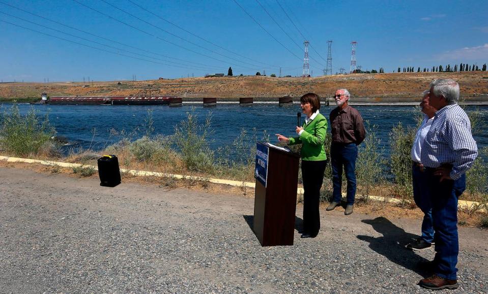 A barge prepares to enter the locks at Ice Harber Dam while Cathy McMorris-Rodgers, R-Wash., joins congressman Dan Newhouse, R-Wash., Mike Collins R-Georgia, and Cliff Bentz, R-Ore., at a news conference Monday.