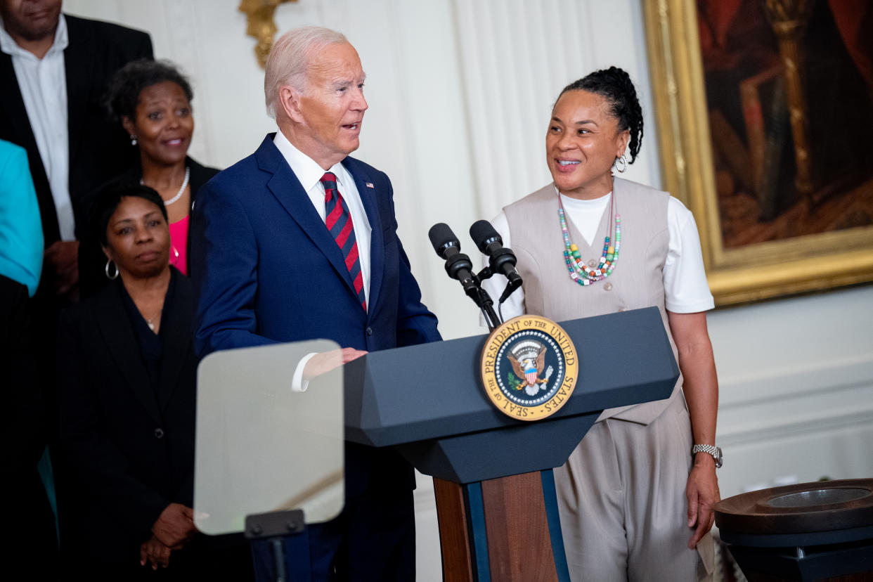 WASHINGTON, DC - SEPTEMBER 10: U.S. President Joe Biden, accompanied by South Carolina Gamecocks Head Coach Dawn Staley (R), speaks during an event to celebrate the 2023-2024 University of South Carolina Gamecocks Women's Basketball NCAA championship team in the East Room at the White House on September 10, 2024 in Washington, DC. The Gamecocks ended their season undefeated and beat the Iowa Hawkeyes 87-75 for their third NCAA Championship with Head Coach Dawn Staley. (Photo by Andrew Harnik/Getty Images)