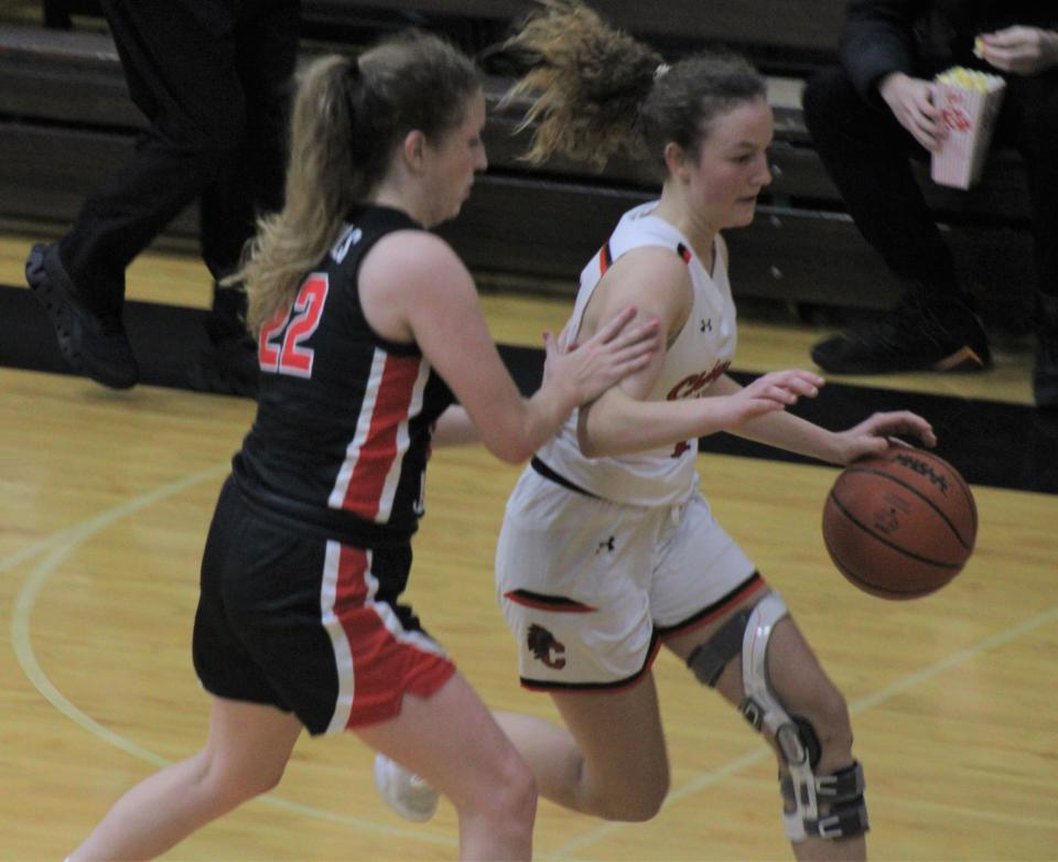 Cheboygan junior guard Emily Clark (right) drives past East Jordan's Lillian Stone (22) during the second half on Monday.