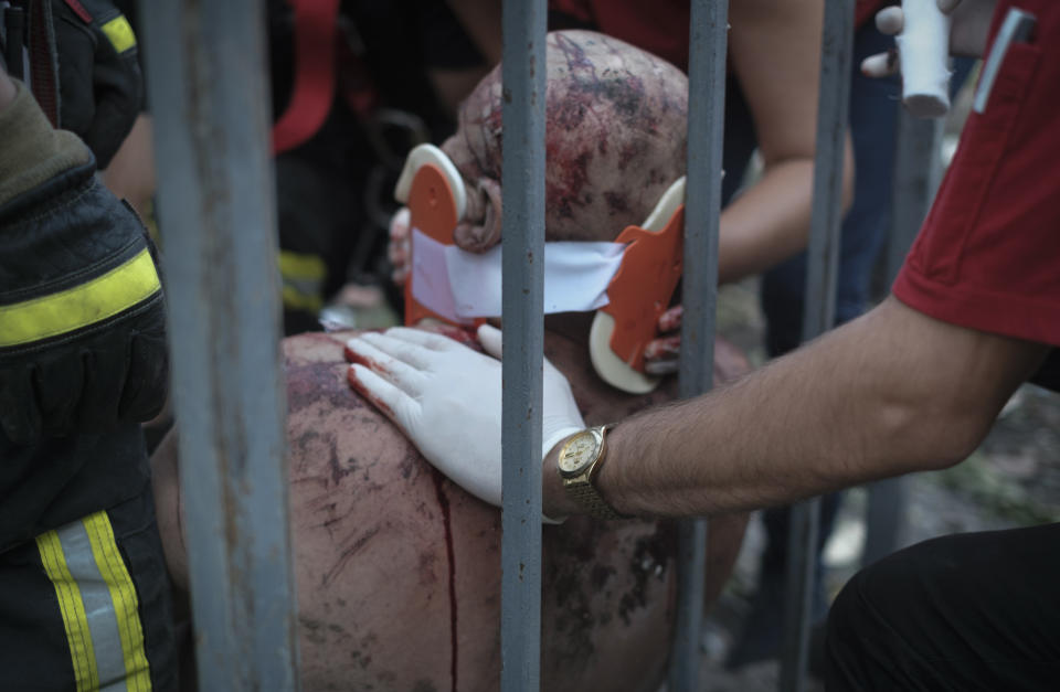 Ukrainian emergency service personnel help an injured local resident after Russian shelling in Mykolaiv, Ukraine, Wednesday, June 29, 2022. (AP Photo/George Ivanchenko)