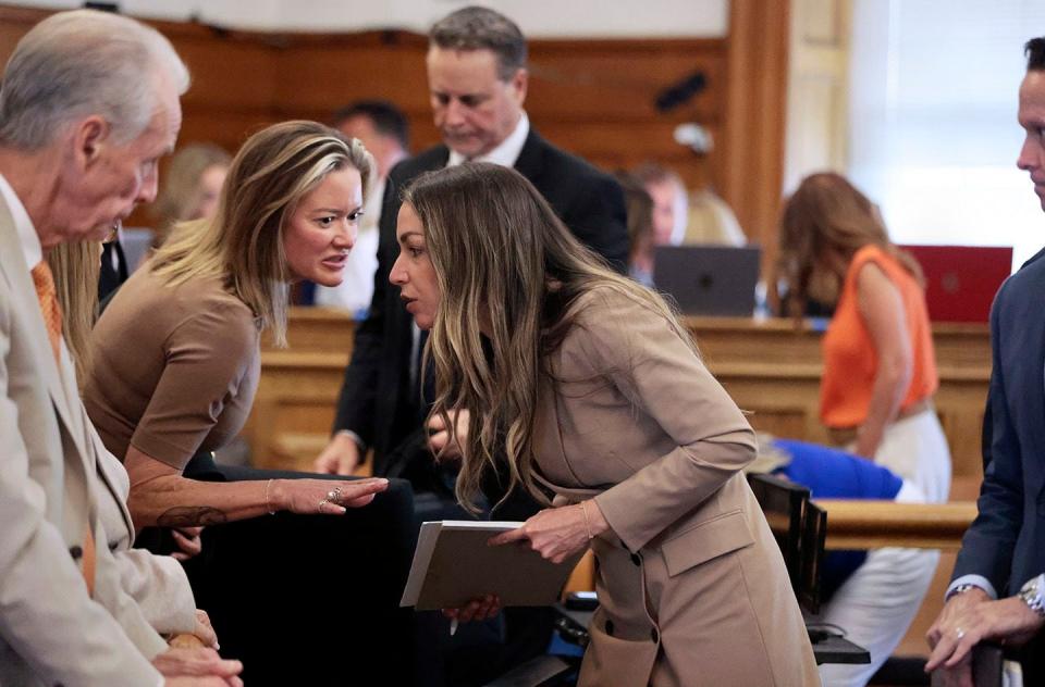 Karen Read listens to family members, after the jury is dismissed at the end of the evidence phase of her murder trial at Norfolk Superior Court, in Dedham, Mass., Monday, June 24, 2024. Read is accused of backing her SUV into her Boston Police officer boyfriend, John O'Keefe, and leaving him to die in a blizzard in Canton, in 2022. (Pat Greenhouse/The Boston Globe via AP, Pool)