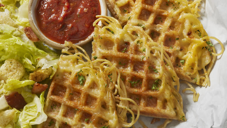 Spaghetti waffles with salad and sauce